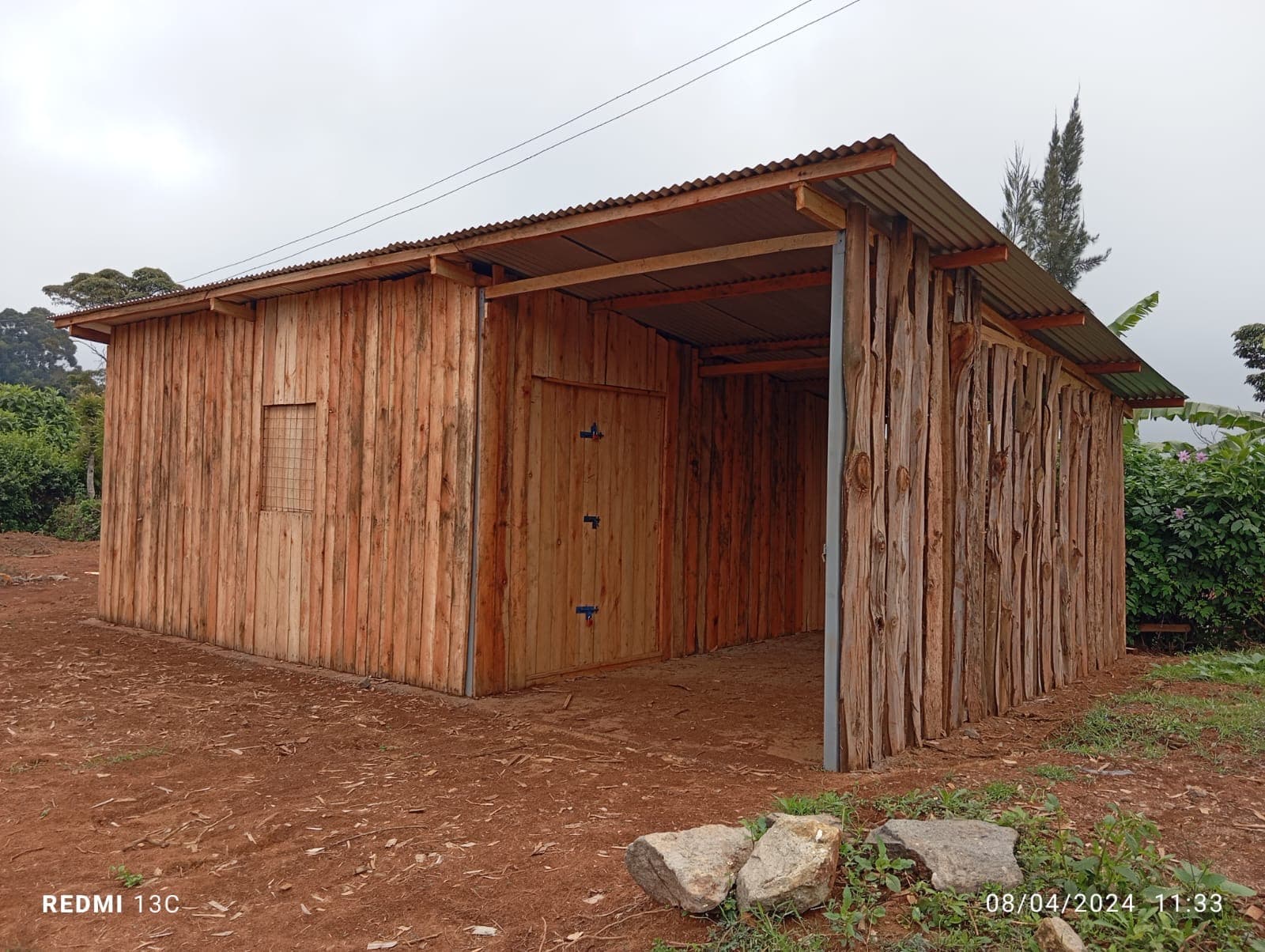 Completed wooden building with metal roofing and covered areas