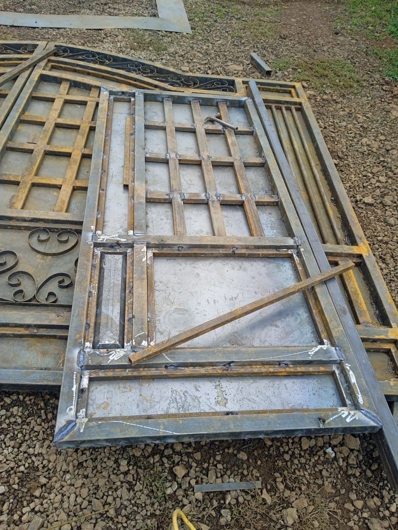 Close-up of metal gate frame construction showing grid pattern