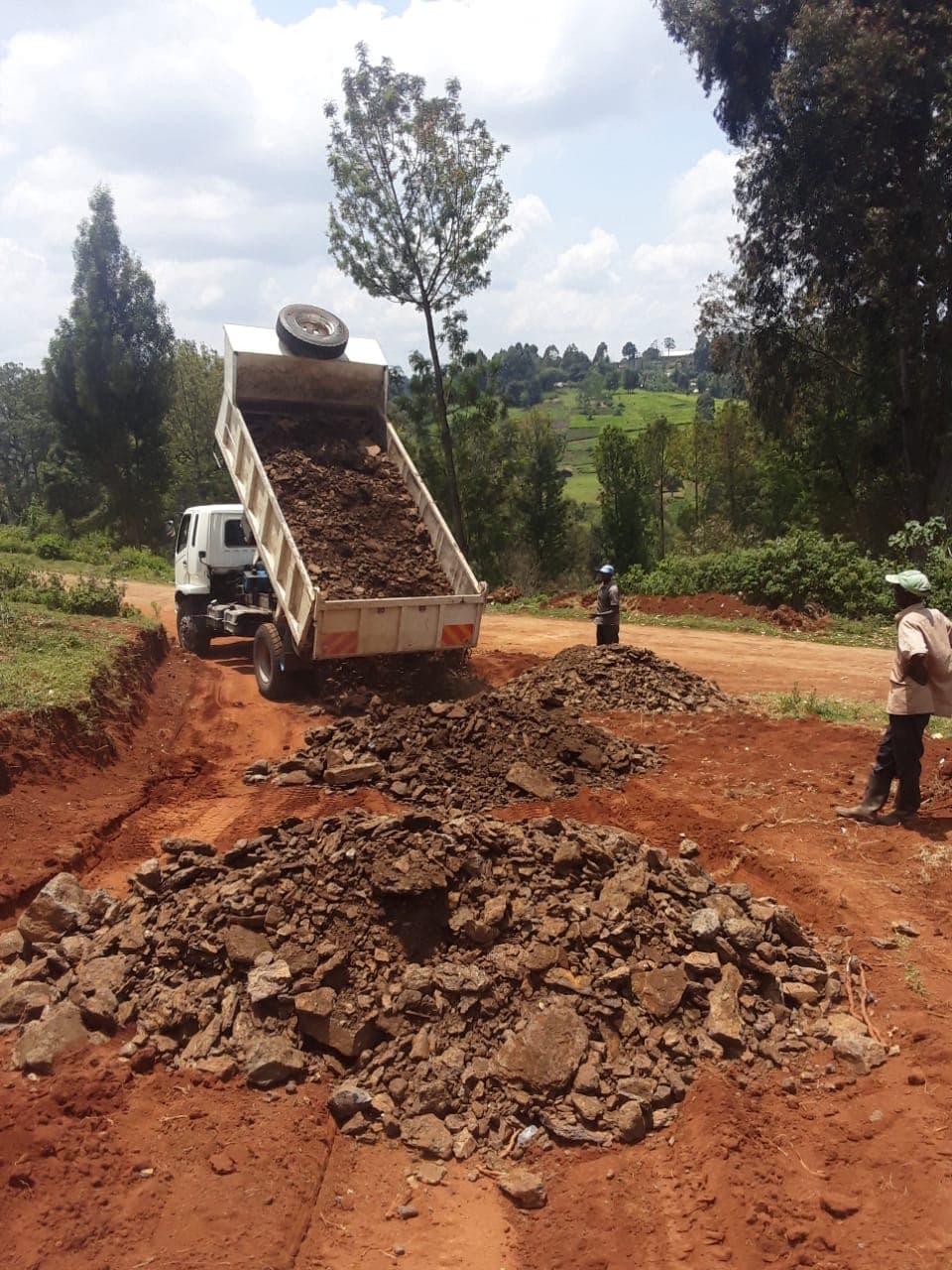 Dump truck delivering gravel for road and foundation work