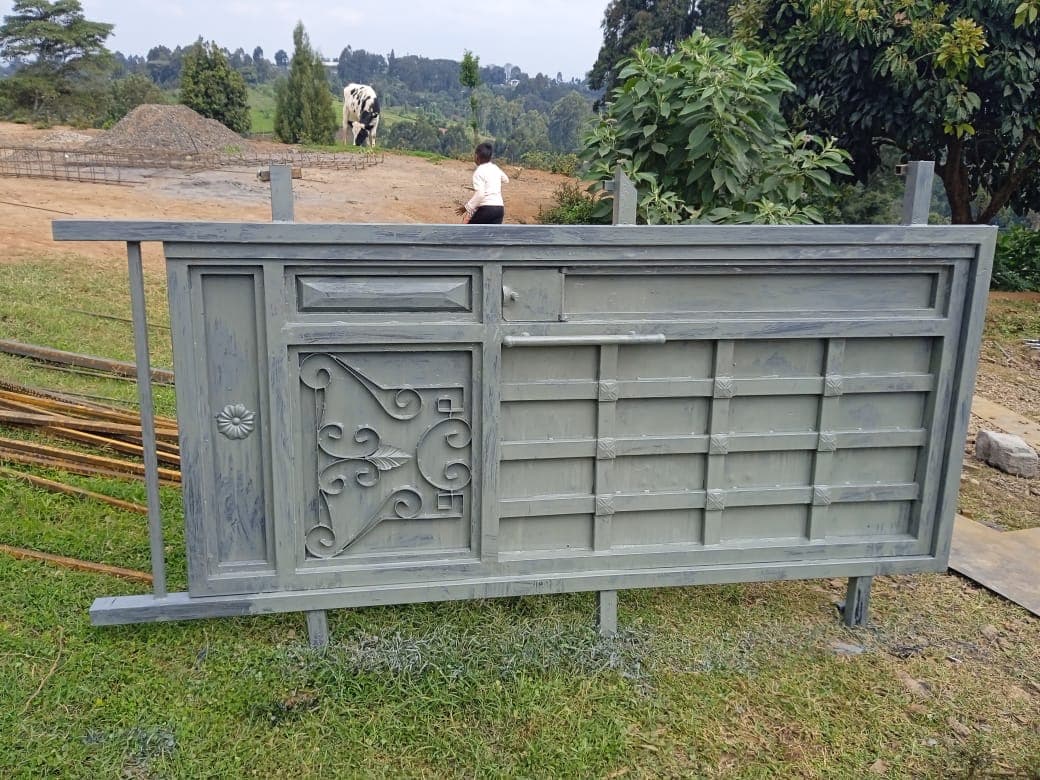 Completed painted metal gate panel with floral scrollwork design