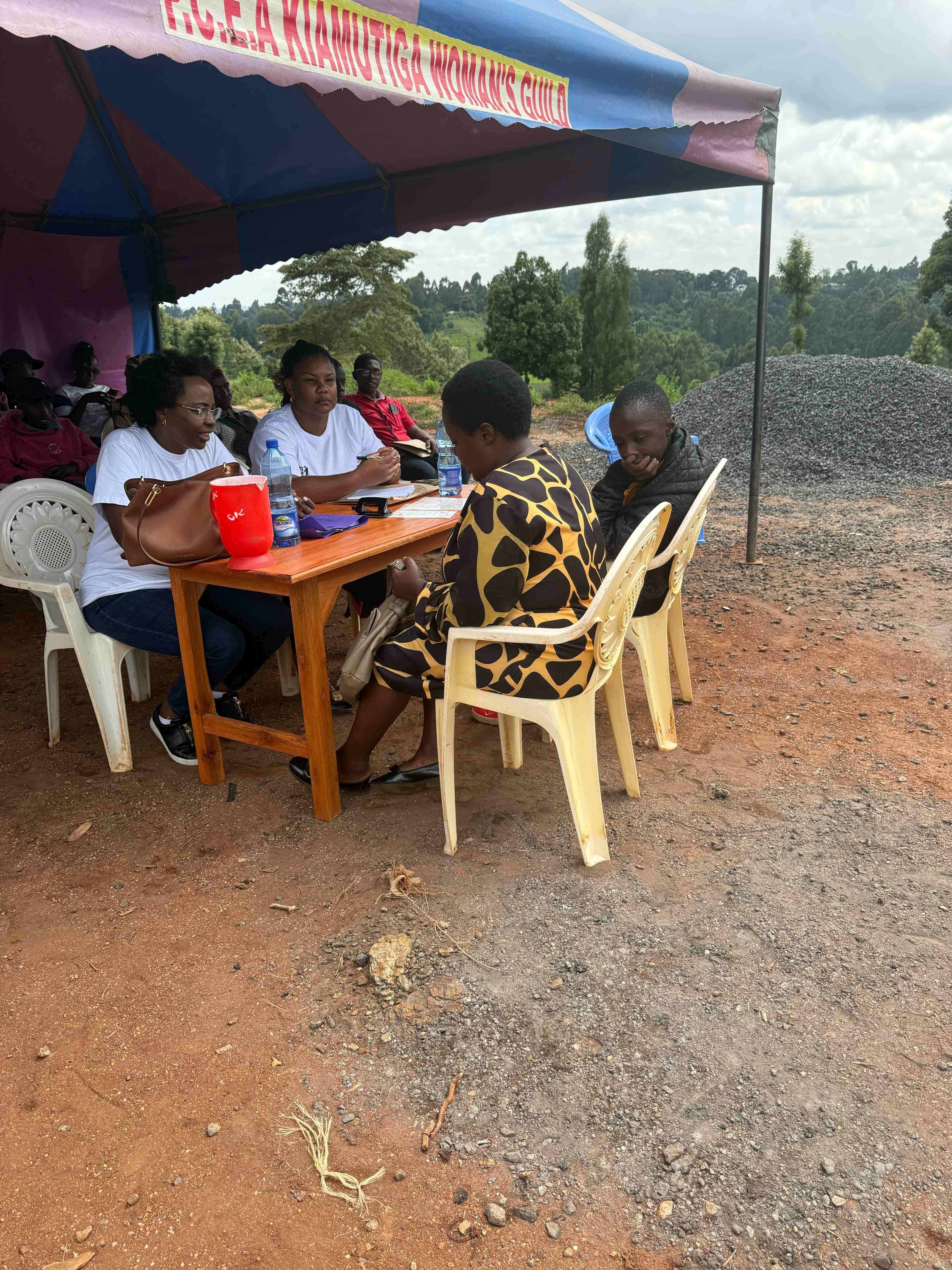 Githima registration session with family members at PCEA Kiamutiga Women's Guild event