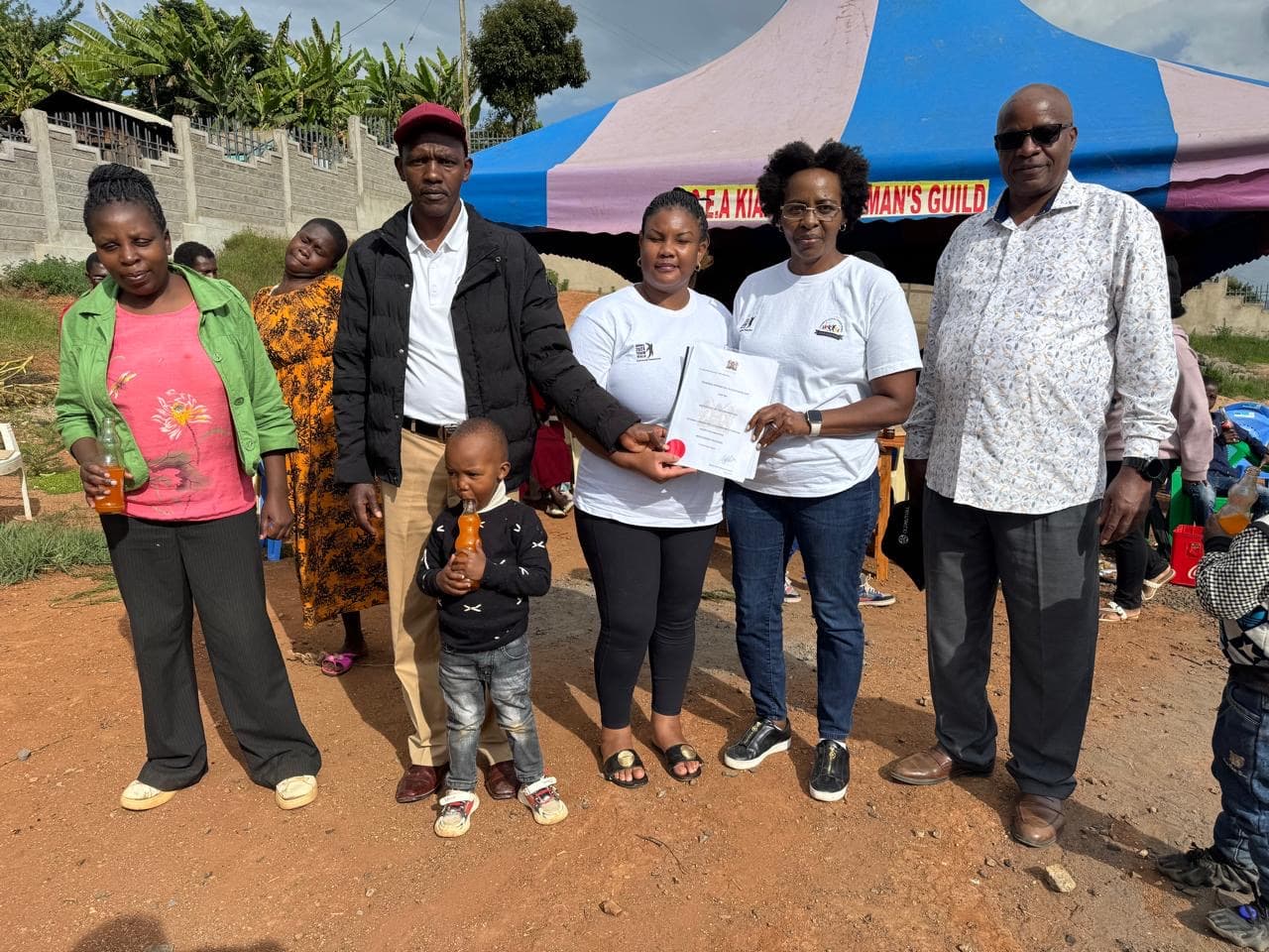 Extended family gathering with community members at Githima event