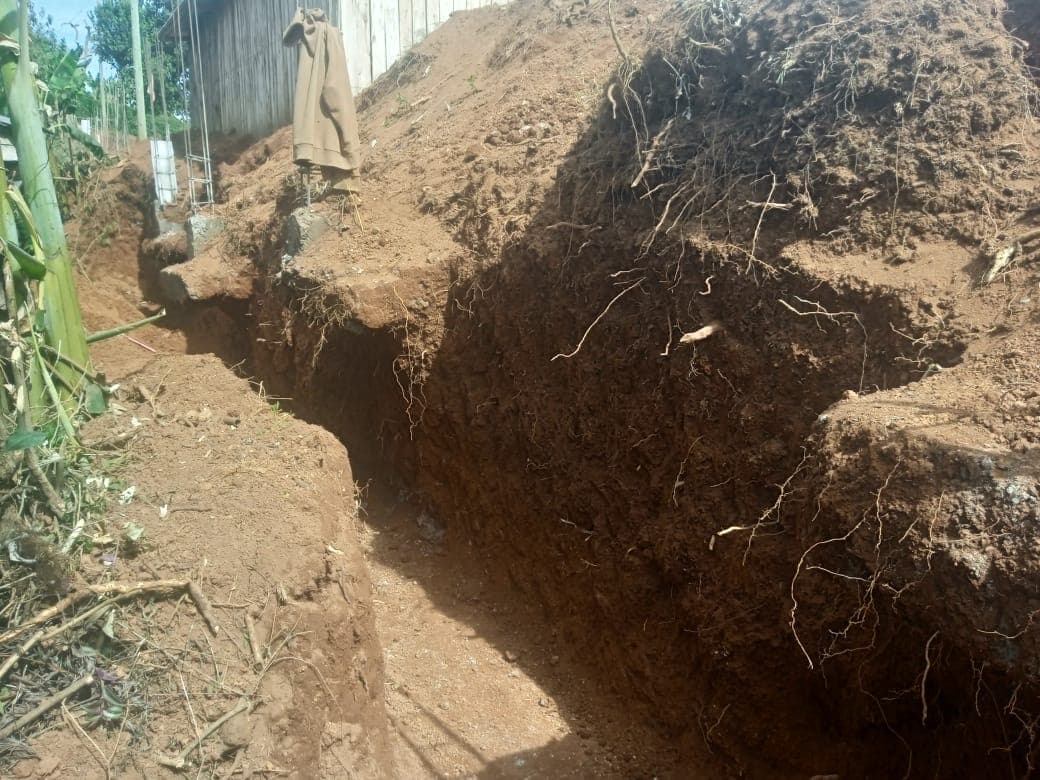 Deep excavation trench showing soil layers for foundation