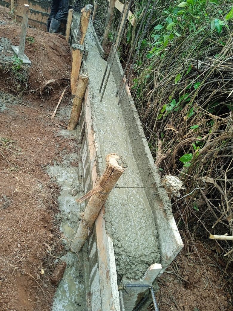 Fresh concrete foundation wall with wooden formwork