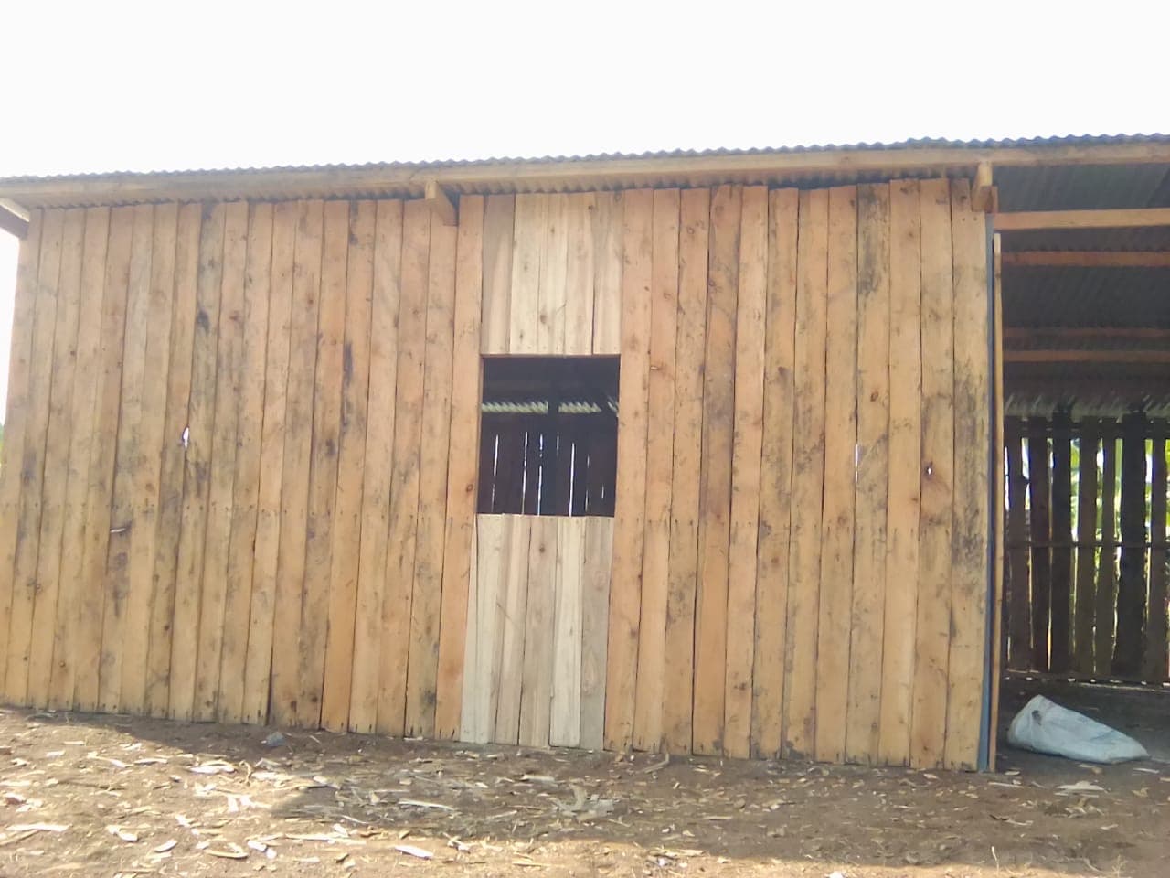 Wooden wall with vertical timber planks and window installed